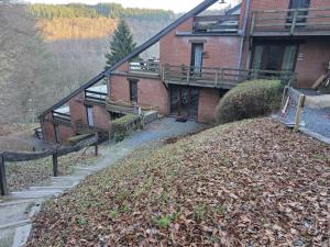 a building with a pile of leaves in front of it at L'Orée du bois in Membre