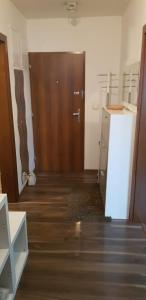 an empty room with a door and a wooden floor at Apartman Zvolen in Zvolen