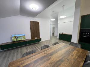 a conference room with a wooden table and chairs at Rădăuți Residence 3 in Rădăuţi +7 photos