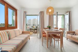 a living room with a couch and a table at Apartamentos Playa Marina in Cala Ferrera