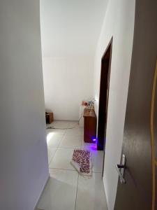 a room with a door and a rug on the floor at Suíte na praia do amor in Conde