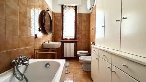 a bathroom with a tub and a toilet and a sink at N294 - Numana, ampio quadrilocale con giardino e wifi in Numana +18 photos
