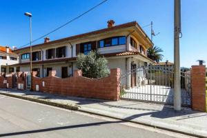 a brick house on the side of a street at AnaeleHouseapartments LTB in Arborea