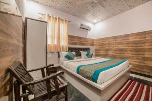 a bedroom with a bed and a wooden wall at Hotel O krishna in Noida +20 photos