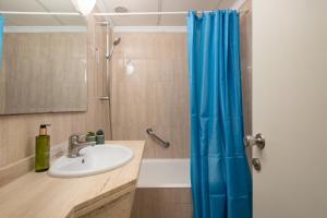 a bathroom with a sink and a shower at Apartamentos Playa Marina in Cala Ferrera +25 photos
