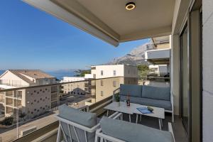 a balcony with chairs and a table with a view at Apartment Adriatic Pearl -Makarska Exklusiv in Tučepi