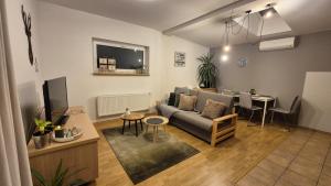 a living room with a couch and a table at Penzion Jelínek in Opočno
