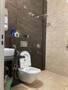 a bathroom with a toilet and a shower at Stay in peace in Dehradun +23 photos