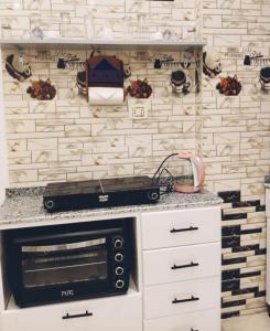 a kitchen with a counter with a microwave oven at NOOR SEEN House in Luxor