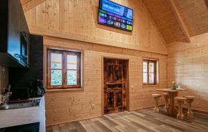a kitchen with a tv on the wall of a cabin at Chalet In Stainz in Stainz
