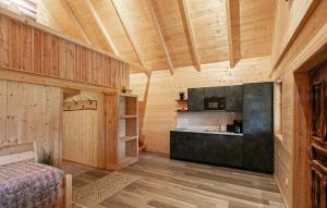 a room with a kitchen with wooden walls and wooden floors at Chalet In Stainz in Stainz