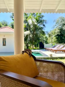 a yellow purse sitting on a bench next to a pool at Madhu Villa in Weligama