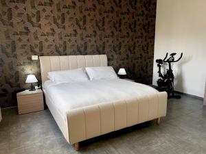 a large white bed in a room with a wall at Hotel Bastione in Brindisi +40 photos