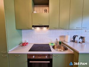 a kitchen with a sink and a stove top oven at 365PAM - Apartament 5 Mórz - BASEN, PLAC ZABAW, PARKING W CENIE in Sianozety