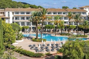 an aerial view of a resort with a pool and lounge chairs at FERGUS Club Font de Sa Cala Beach in Capdepera