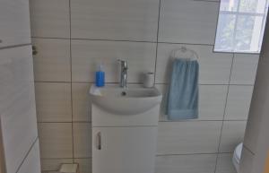 a bathroom with a sink and a blue towel at Naval Hill Nook in Bloemfontein