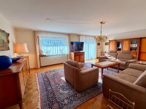 a living room with couches and a rug at FeWo Reserl in Bischofswiesen
