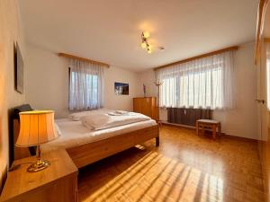 a bedroom with a bed and a lamp in it at FeWo Reserl in Bischofswiesen