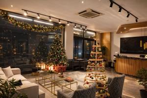 a living room with a christmas tree in it at Moja City Hotel in Istanbul