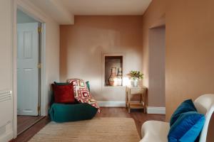 a living room with a couch and a chair at Stylish Harbourfront Apartment in Torquay