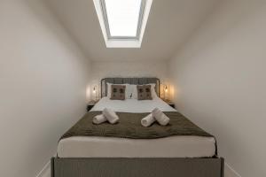 a bedroom with a large bed with two pillows at The Bliss House in Lourinhã