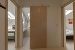 a room with a wooden door leading to a bedroom at The Bliss House in Lourinhã +24 photos