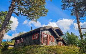 a small house with red windows on a hill at Gorgeous Home In Eggedal With Sauna in Eggedal +19 photos