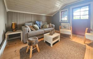 a living room with a couch and a chair at Gorgeous Home In Eggedal With Sauna in Eggedal