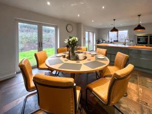 a kitchen and dining room with a table and chairs at Achandoilach House in Strathcarron