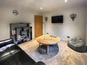 a living room with a table and a couch at Achandoilach House in Strathcarron
