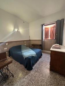 a bedroom with a blue bed and a window at Cap Corse - Grande maison au bord de mer - PMR in Grillasca