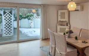 a dining room with a table and chairs and a sliding glass door at Amazing Home In Hundested With Wifi in Hundested