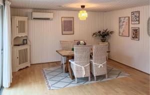 a dining room with a wooden table and chairs at Amazing Home In Hundested With Wifi in Hundested