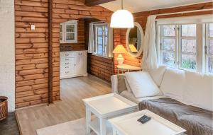 a living room with a couch and a table at Amazing Home In Hundested With Wifi in Hundested