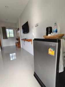a kitchen with a refrigerator with a sign on it at Chiang Khan Dwelling in Chiang Khan