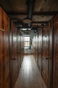 a row of wooden lockers in a hallway at Turn Hostel in Ljubljana