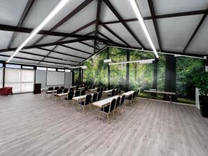 a large room with tables and chairs in it at Gran Hotel Botánicos in Teruel