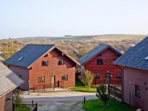 a group of houses with red and black roofs at Ash Lodge - Retallack in Saint Columb Major