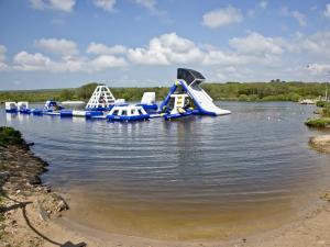 a water park with a slide in the water at Ash Lodge - Retallack in Saint Columb Major +19 photos