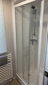 a shower with a glass door in a bathroom at B10 - The Escape Pod in Heysham +12 photos