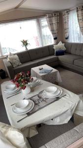 a living room with a table and a couch at B10 - The Escape Pod in Heysham