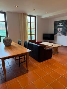a living room with a table and a couch at Scheune B7 in Düsseldorf