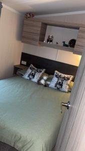 a bedroom with a bed with two pillows on it at B10 - The Escape Pod in Heysham