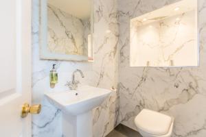 a white bathroom with a sink and a toilet at Ilkley Riverside Hotel in Ilkley