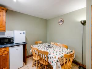 a kitchen with a table with chairs and a microwave at The Hayloft - 17238 in York