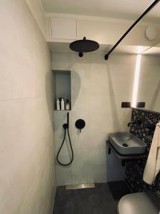 a bathroom with a shower and a sink at Apartamenti Ikšķile in Ikšķile