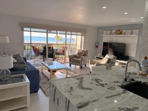 a kitchen and living room with a view of the ocean at Sunset Beach 101 Beach Front Unit in Holmes Beach