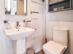 a white bathroom with a sink and a toilet at The Pod - Uk38513 in Babcary