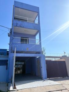 a blue building with a garage in front of it at Banzeiro Hostel in Macapá