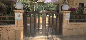 an iron gate in front of a building with plants at Ocean Breeze in Sal Rei +7 photos